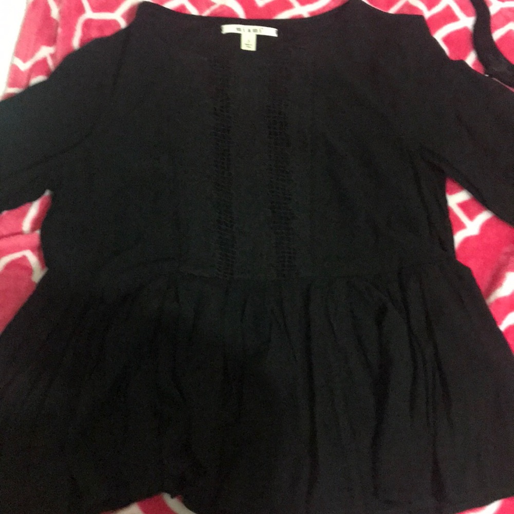 black shirt with fine detailing along the chest